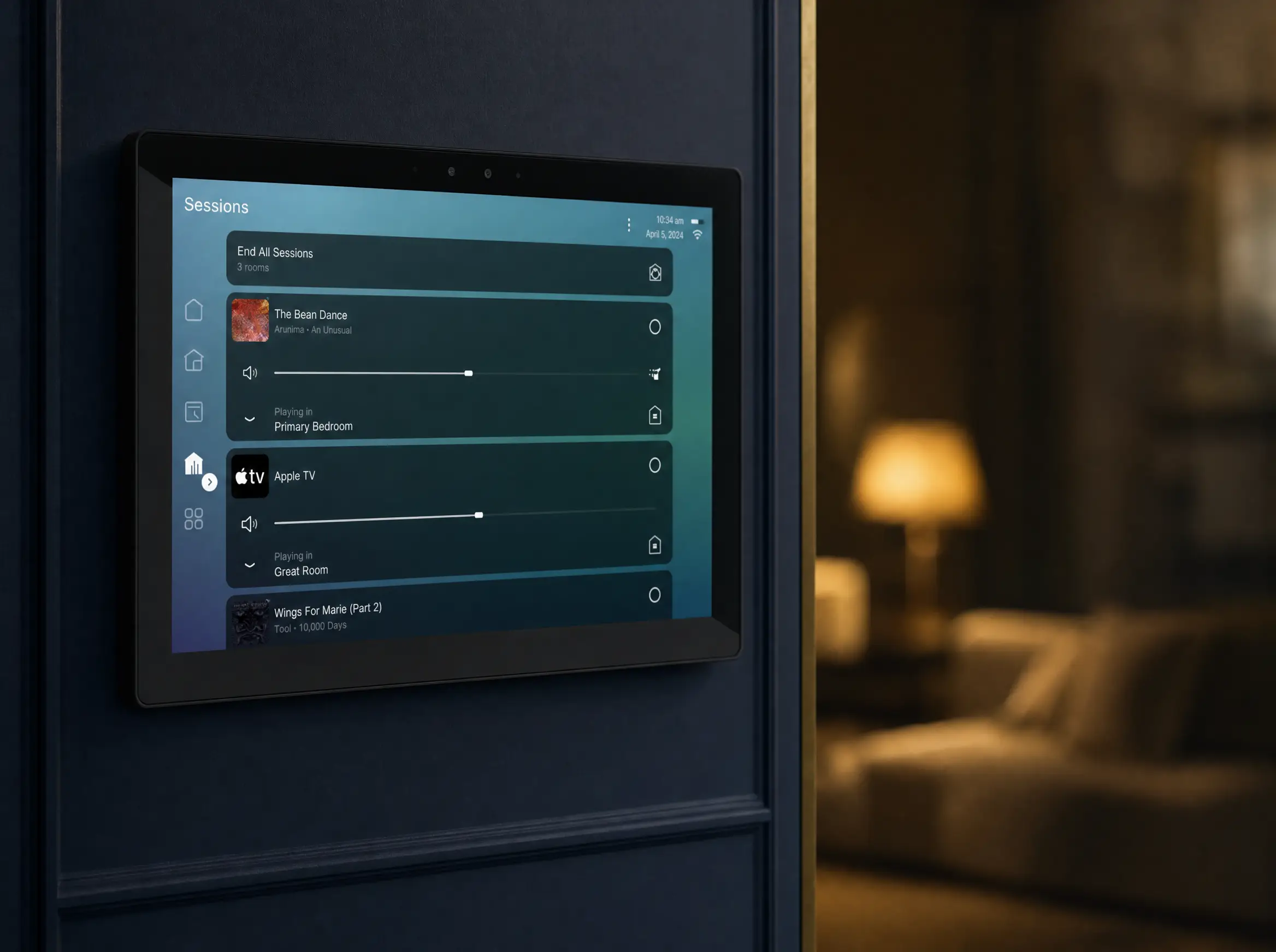A wall-mounted Control4 touchscreen glowing on a navy wall, the room beyond in soft focus